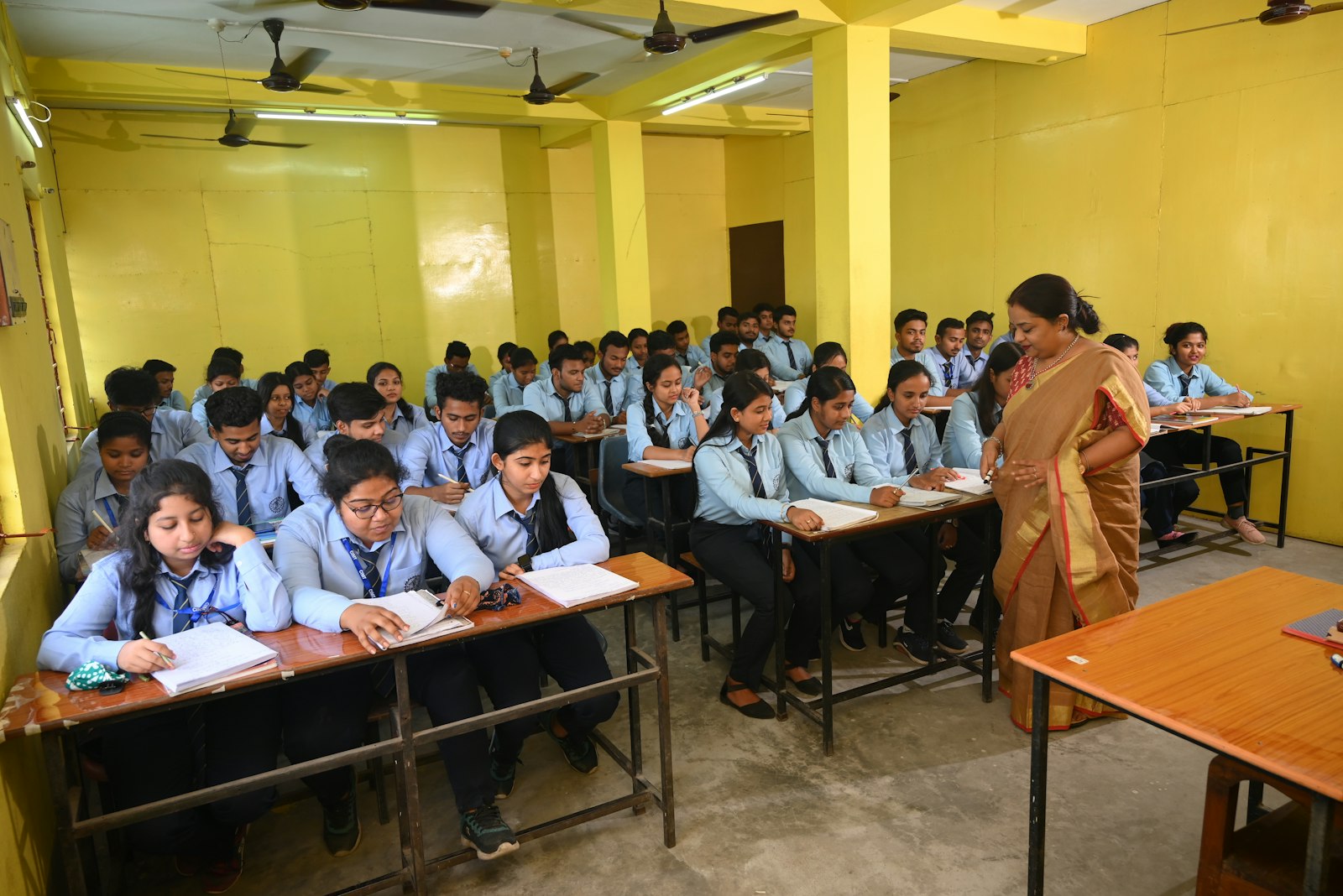 A classroom full of Indian students sitting at desks.