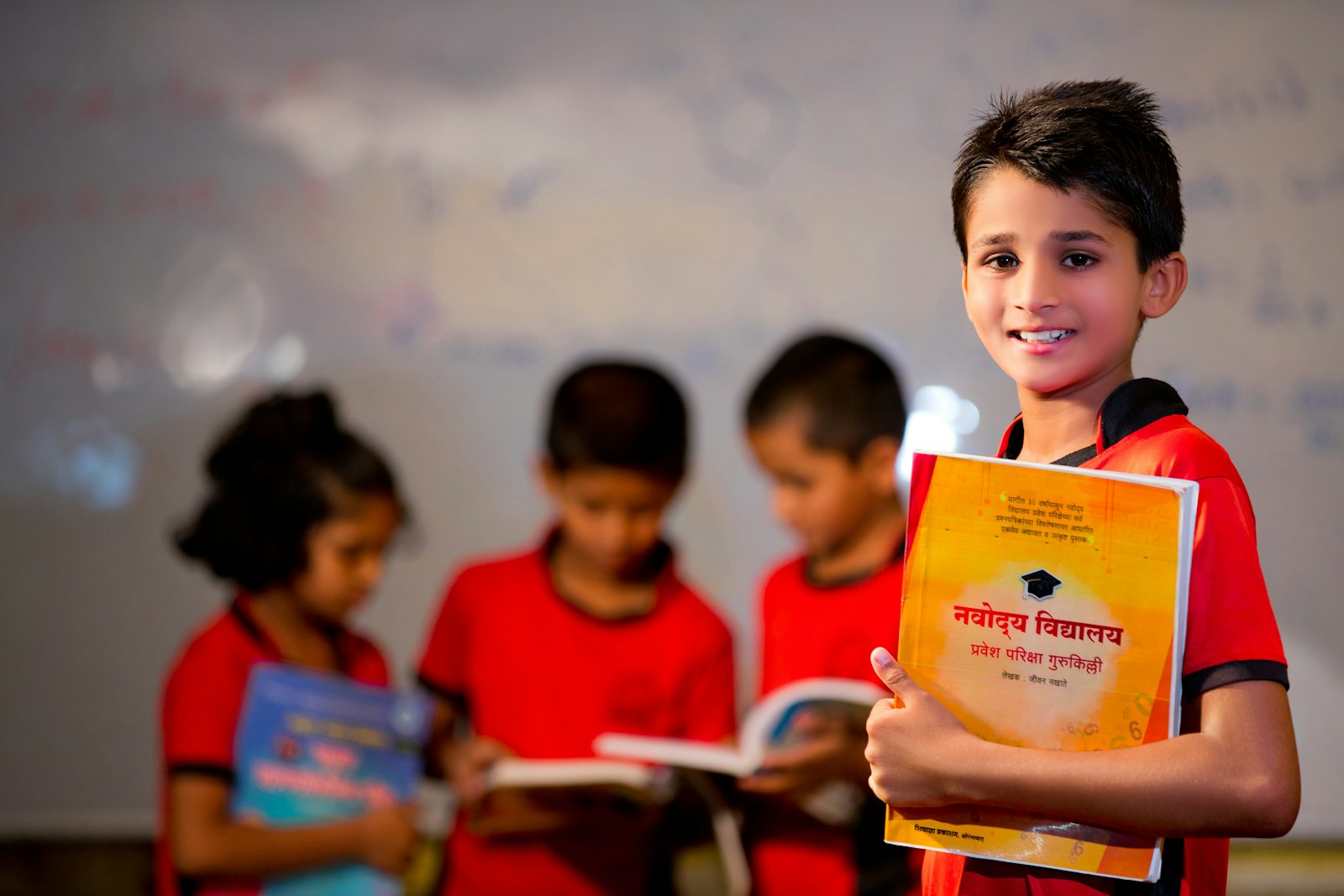 Student holding a textbook while studying