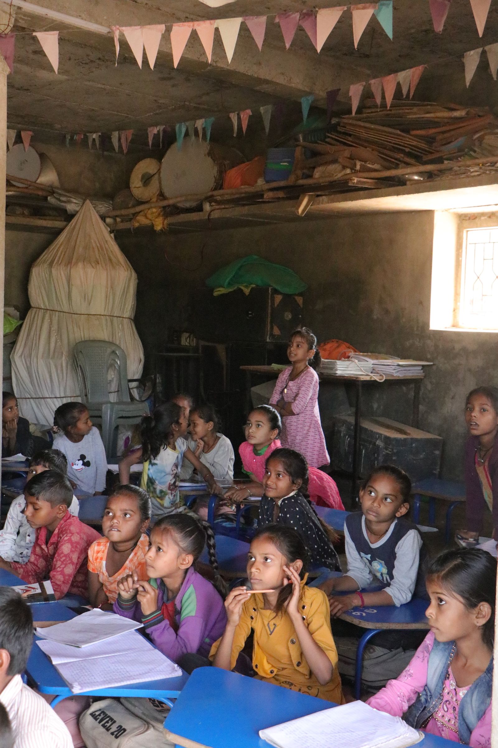 Children learning attentively in a rural classroom in Banaskantha, India.