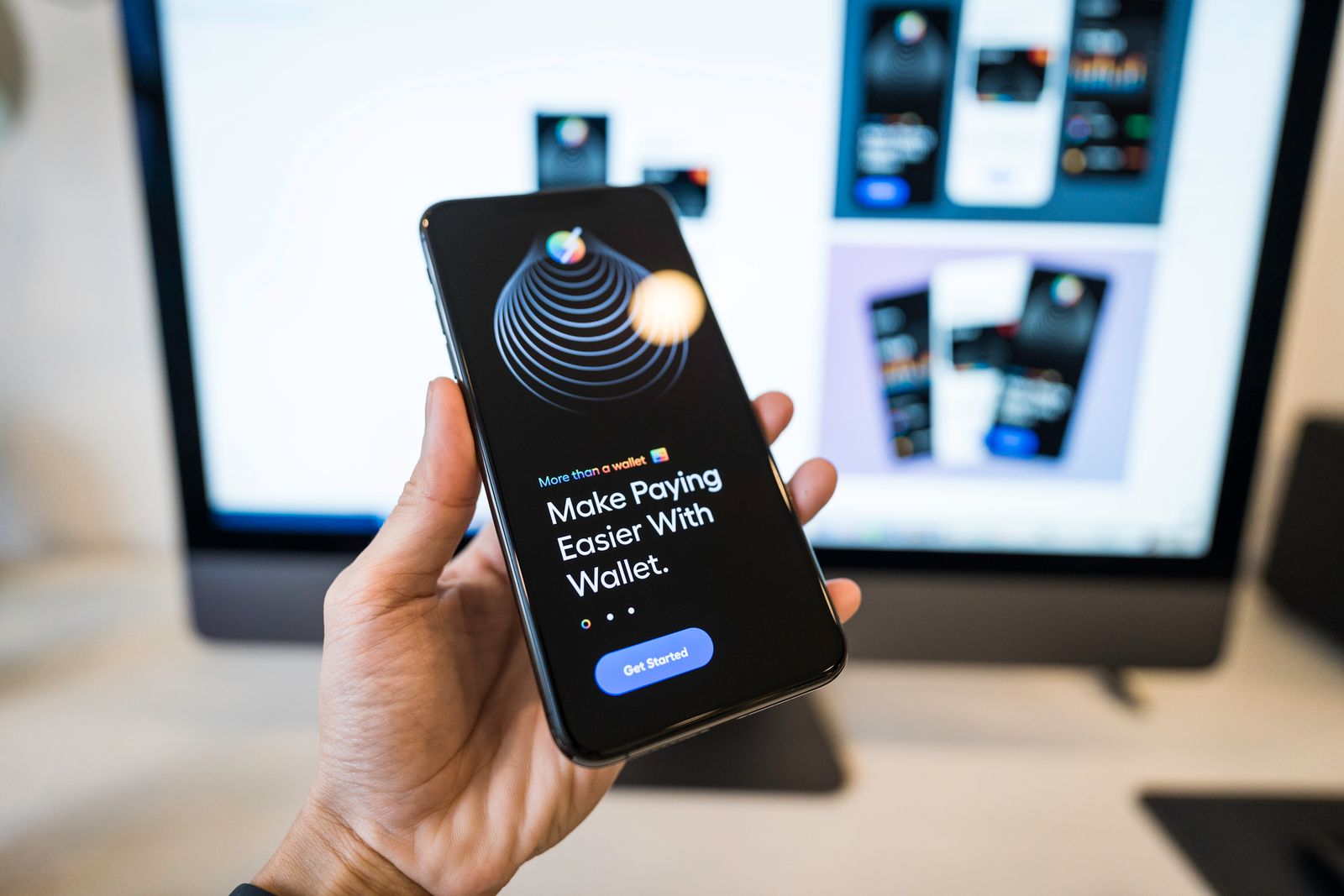 Hand holding a smartphone showing a digital wallet payment app