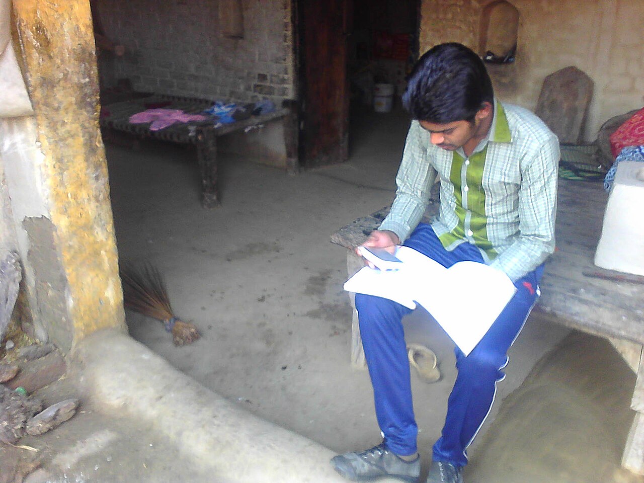 A student in India sitting and studying from notes