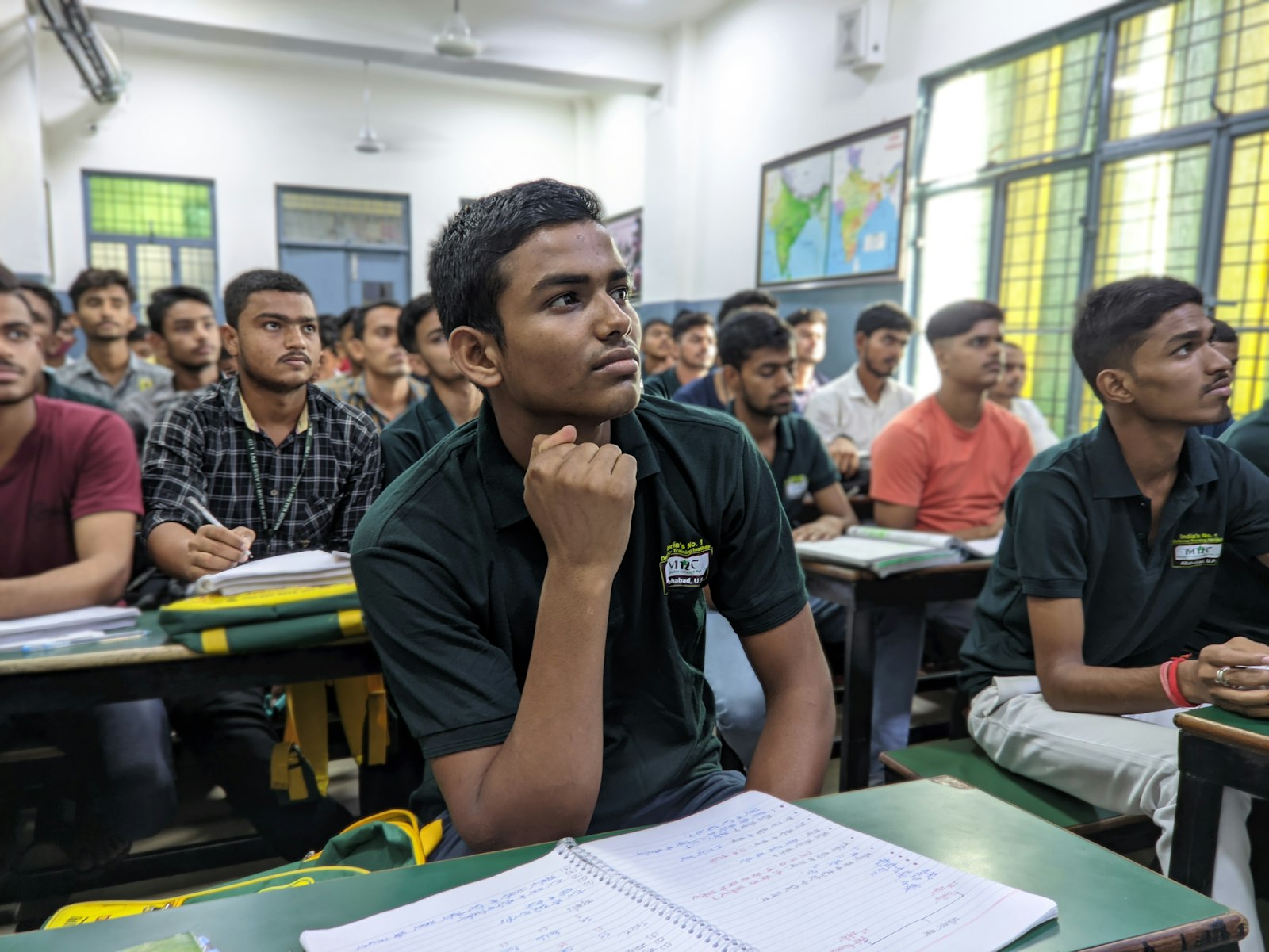 Students sitting at desks in a school classroom, practising for an exam.