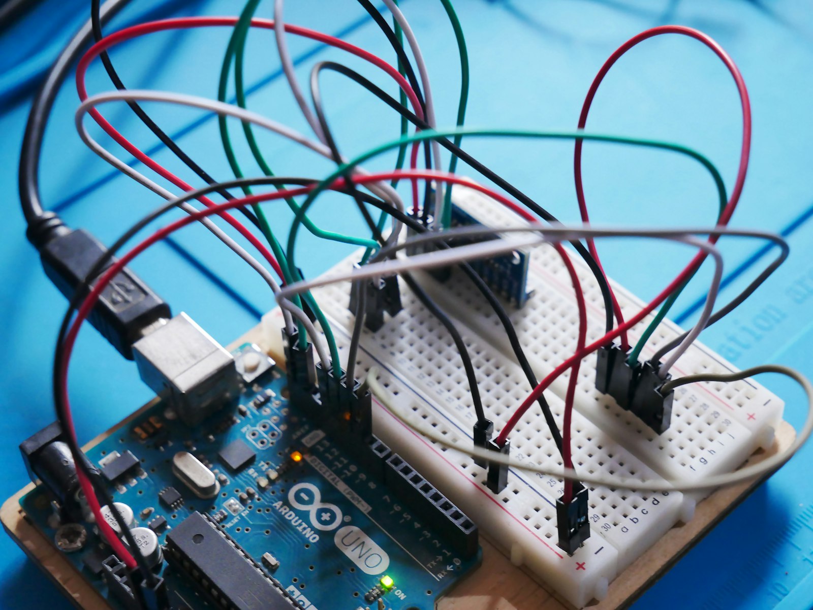 An Arduino Uno board wired to sensors on a breadboard, typical of a school AI and electronics lab.
