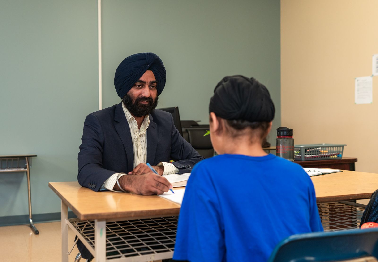Teacher and student in a one-on-one feedback conversation.