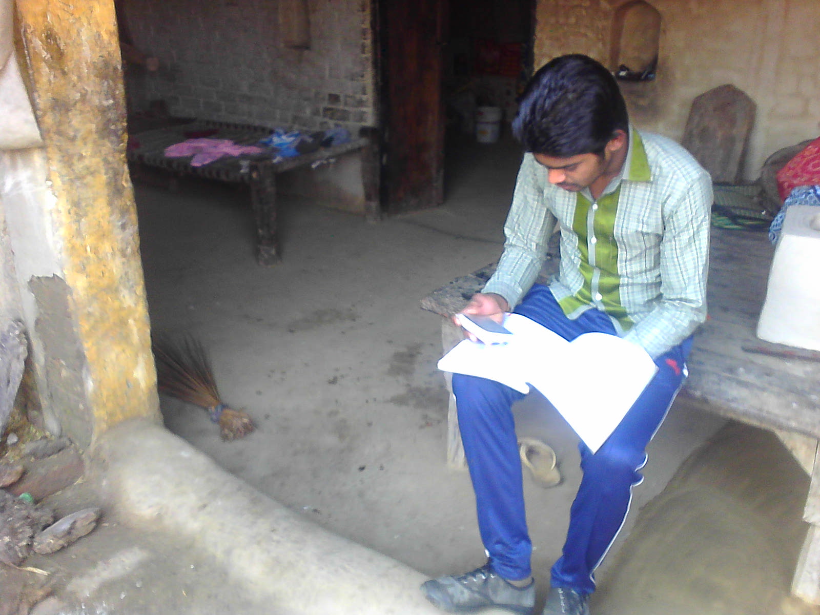 A student in India studying at a desk with books
