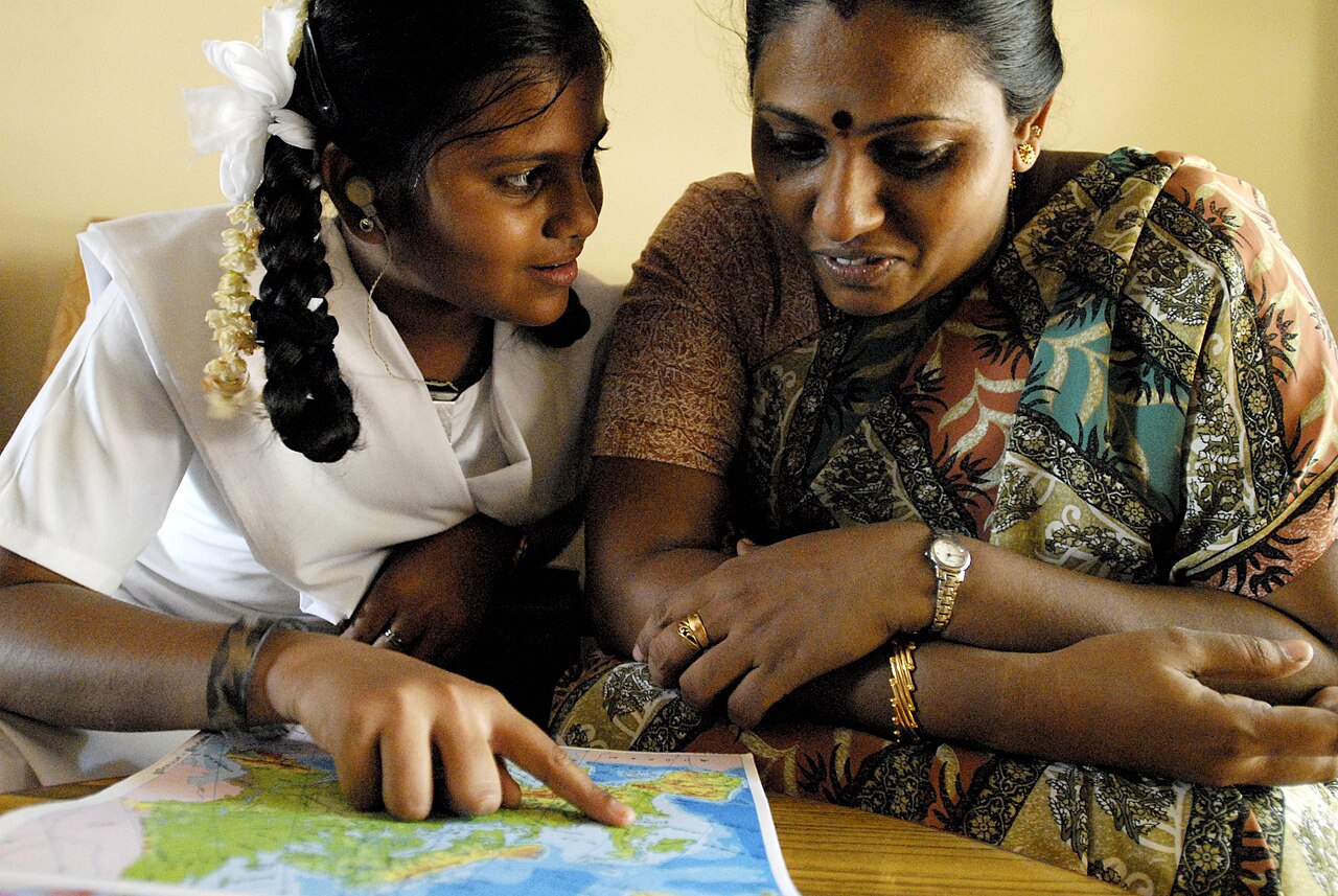A mother and her daughter looking at a map together in a Chennai school classroom