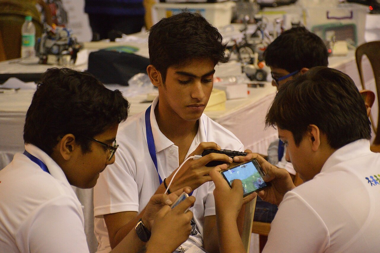Students in Kolkata looking at a mobile phone together
